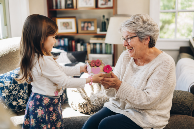 Grandmother smiling at a heartfelt keepsake gift from her grandchild at home